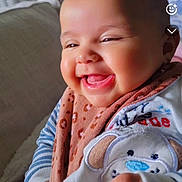 Sofia is registered to the contest to win money with this photo: accessories, baby, babylaughing, bodypart, cushion, face, finger, hand, happy, head, jewelry, laughing, mouth, necklace, newborn, person, photography, portrait, smile, teeth