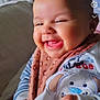 accessories, baby, babylaughing, bodypart, cushion, face, finger, hand, happy, head, jewelry, laughing, mouth, necklace, newborn, person, photography, portrait, smile, teeth