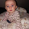 baby, child, infant, portrait, sitting, wide_eyes, looking_at_camera, leopard_print, pink_clothing, long_sleeves, blanket, bedding, teddy_bear, nursery, indoors, close_up, flash_photography, brown_hair, cute, cozy