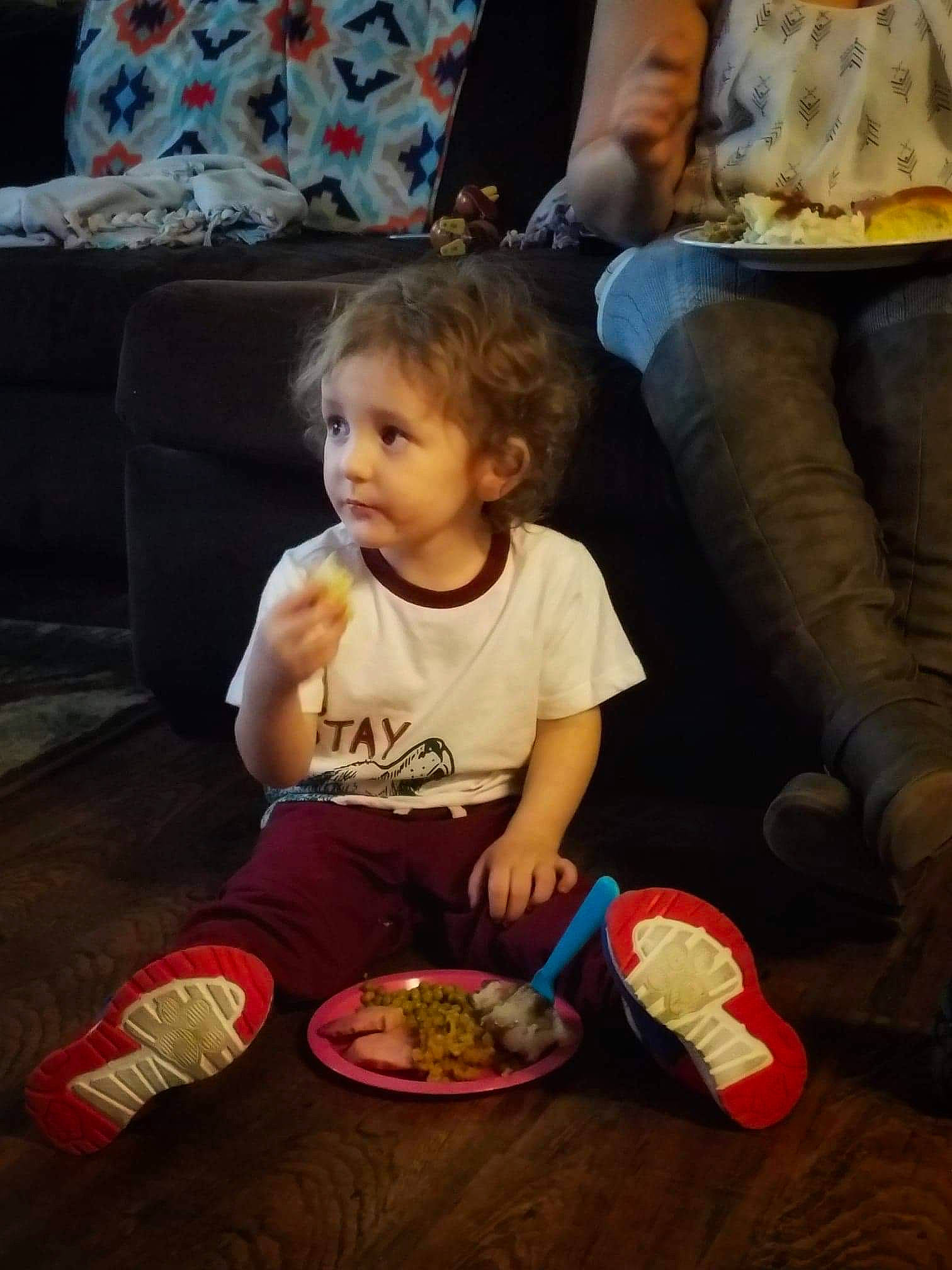 Alexander is registered to the contest to win money with this photo: baby, child, eating, electronic_device, meal, person, play, shoe, sitting, toddler