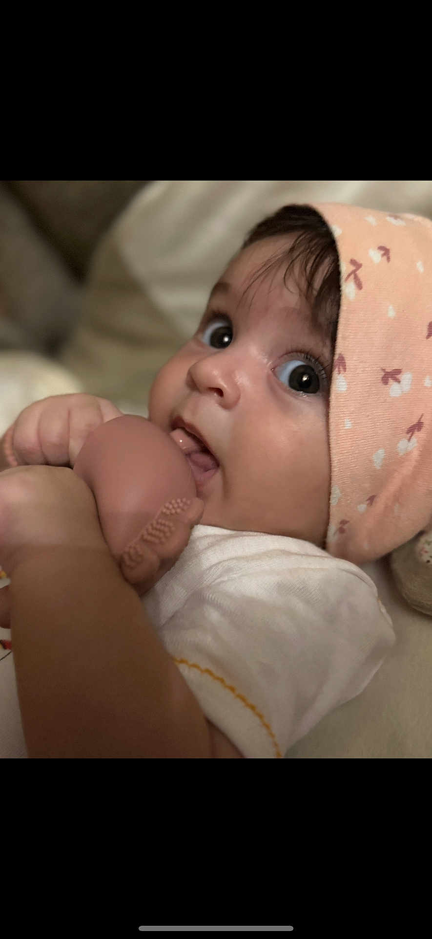 Anaya Maria is registered to the contest to win money with this photo: baby, infant, face, hat, toy, hand, chewing, closeup, curious, expression, skin, clothing, indoor, person, child, cute, soft_toy, headwear, young, portrait