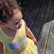 Miracle joined the competition — help win amazing prizes! child, toddler, yellow_dress, bunny_patches, curly_hair, outdoor, wooden_floor, sunlight, shadow, side_view, casual_clothing, cute, young_girl, daylight, summer, colorful, playful, innocence, portrait, person