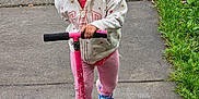 Miracle is registered to the contest to win money with this photo: active, casual_clothing, child, cute, footwear, fun, grass, happy, hoodie, kid, legs, outdoor, person, pink, play, recreation, scooter, sidewalk, smile, toy