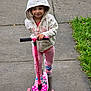 child, scooter, hoodie, pink, sidewalk, outdoor, grass, smile, person, play, toy, casual_clothing, footwear, legs, happy, cute, active, kid, recreation, fun
