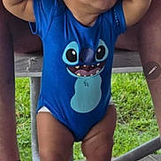 Monklare joined the competition — help win amazing prizes! toddler, child, baby, blue_onesie, cartoon_character, hands, adult, outdoor, grass, wooden_surface, feet, legs, person, support, casual_clothing, standing, curious, holding_hands, daylight, tattoo