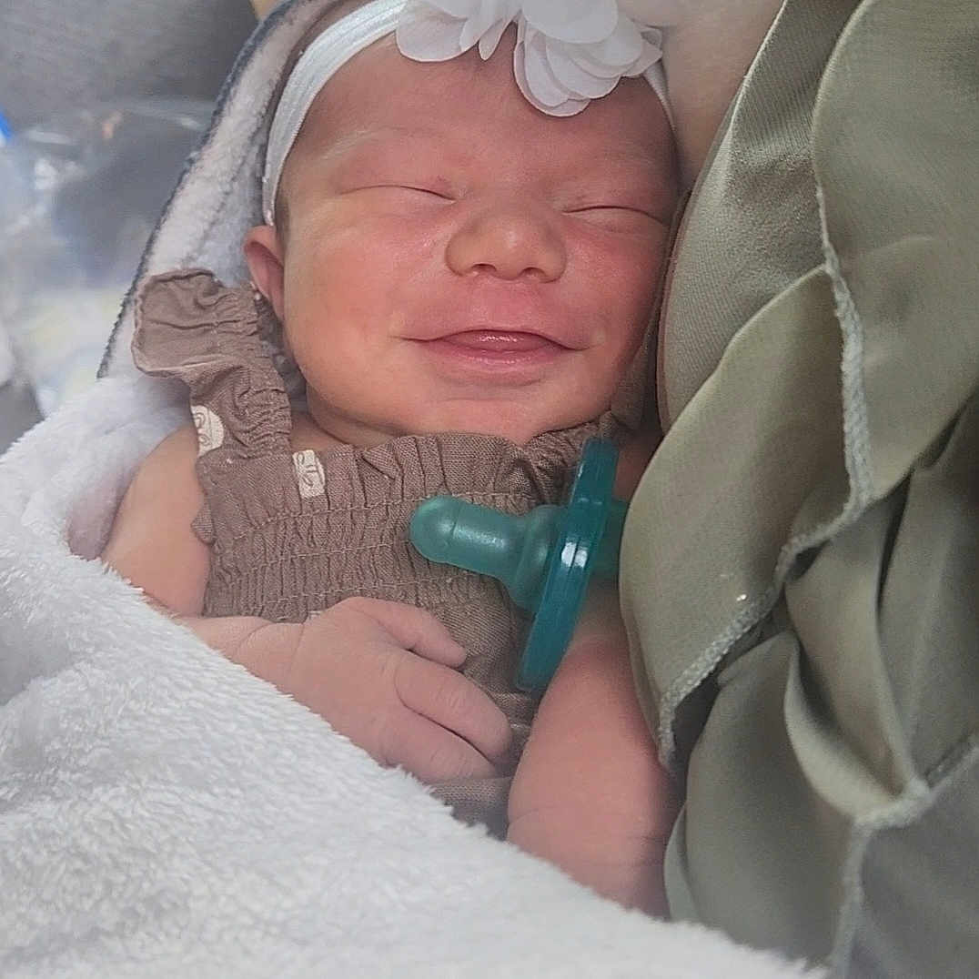 Hellena is registered to the contest to win money with this photo: baby, blanket, child, closeup, cozy, cute, fabric, flower, hand, headband, indoors, infant, newborn, pacifier, peaceful, portrait, sleeping, smiling, soft, wrapped