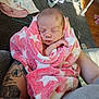 Hellena is registered to the contest to win money with this photo: newborn, baby, blanket, pink, white, stars, tattoo, arms, sleeping, peaceful, cozy, indoor, carpet, person, holding, soft, closeup, infant, wrapped, resting