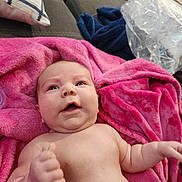 Hellena is registered to the contest to win money with this photo: baby, infant, blanket, pink, couch, pillow, fist, skin, indoors, child, expression, face, person, soft, cozy, furniture, relaxing, young, cute, plush