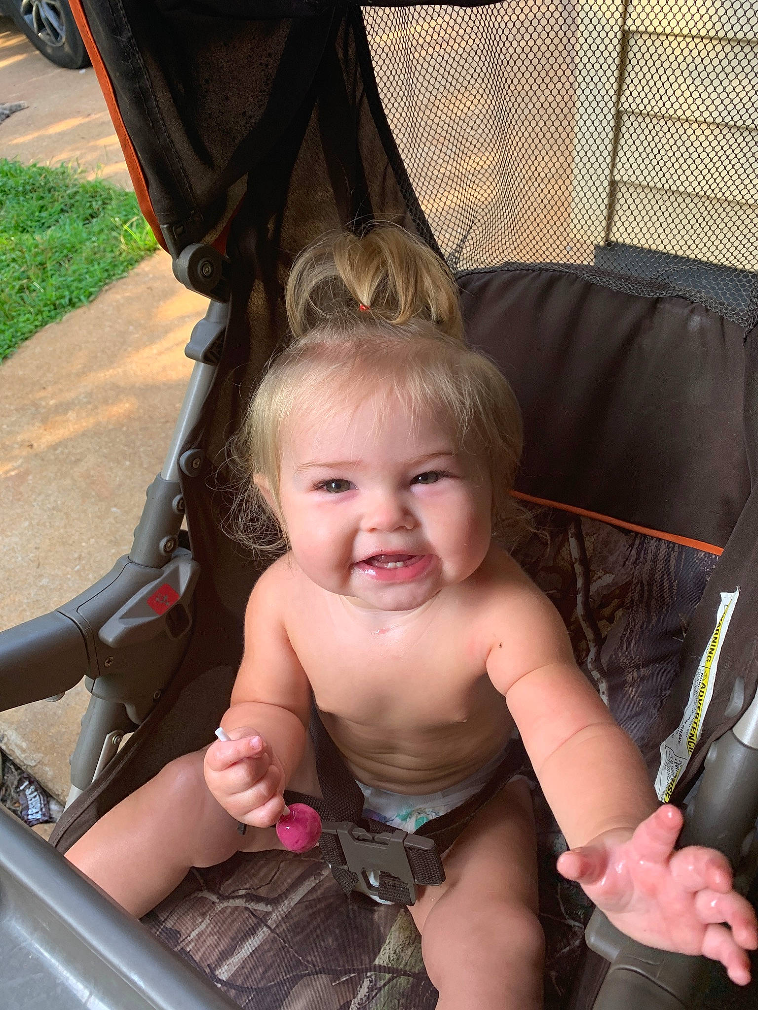 Serenity is registered to the contest to win money with this photo: baby, baby_carriage, baby_products, child, eye, face, finger, fun, hammock, hand, head, leg, person, product, sitting, skin, smile, summer, toddler, tree