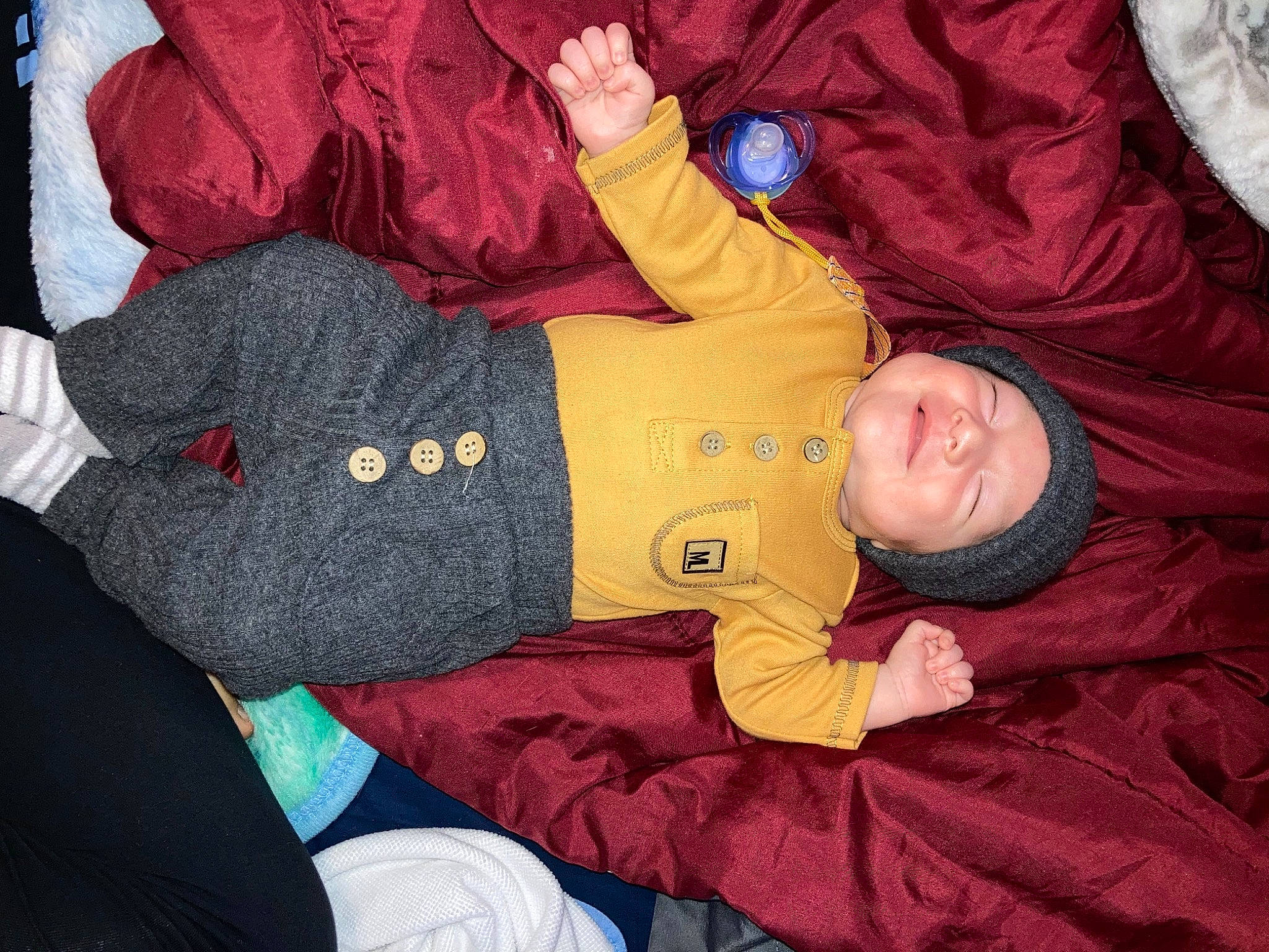 Yaél joined the competition — help win amazing prizes! arm, baby, baby_toddler_clothing, cheek, child, comfort, facial_expression, fun, hand, head, headwear, human_body, jacket, lap, outerwear, person, product, red, room, sleeve