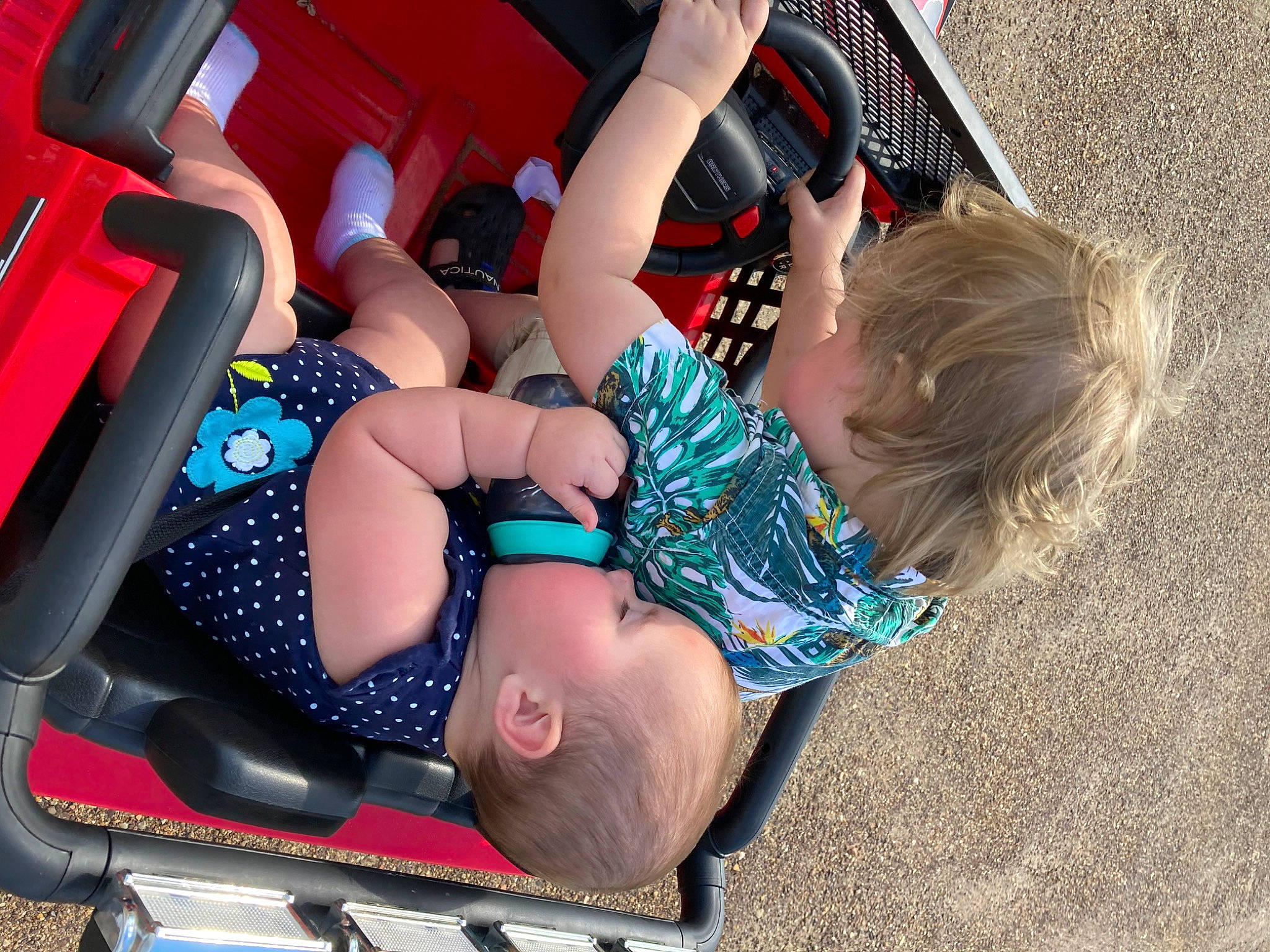 Noa Grace is registered to the contest to win money with this photo: auto_part, automotive_design, automotive_exterior, automotive_tire, automotive_wheel_system, bumper, car, car_seat, car_seat_cover, child, fun, human_leg, knee, leisure, motor_vehicle, person, recreation, shorts, thigh, toddler