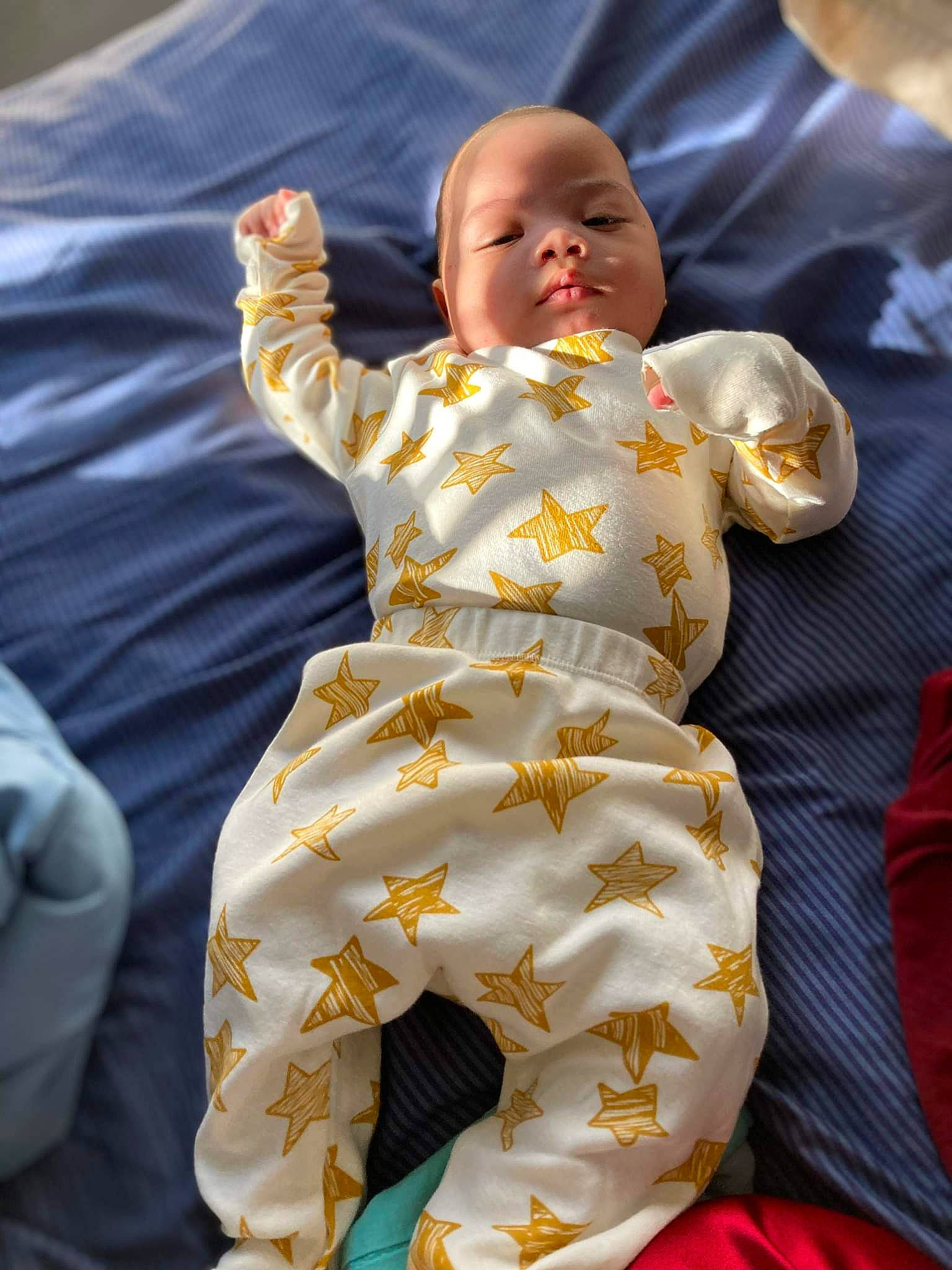 Kyson is registered to the contest to win money with this photo: abdomen, baby, baby_products, baby_toddler_clothing, bed_sheet, bedding, bedtime, child, comfort, event, fun, happy, linens, person, play, sitting, sleeve, textile, toddler, tradition