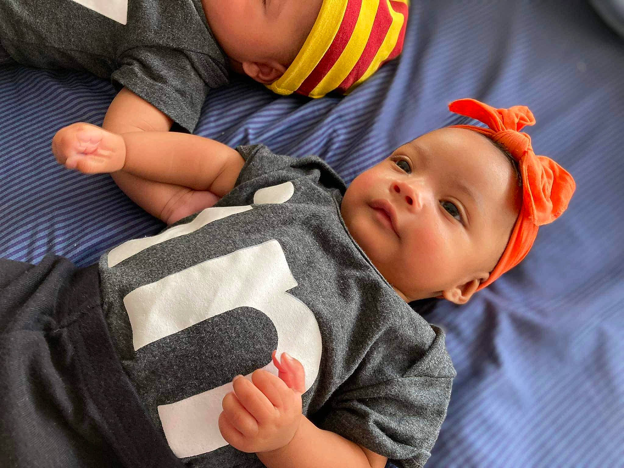 Kynzli joined the competition — help win amazing prizes! baby, baby_toddler_clothing, cheek, child, comfort, facial_expression, finger, gesture, head, headwear, lip, mouth, nail, nose, orange, person, product, skin, sleeve, textile