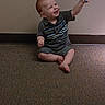 toddler, child, balloon, red_hair, carpet, indoor, smiling, sitting, shorts, shirt, barefoot, happy, playful, person, young_child, wall, floor, holding, toy, casual