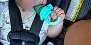 Easton joined the competition — help win amazing prizes! baby, child, car_seat, teething_toy, water_bottle, cap, blue_eyes, sitting, straps, clothing, infant, closeup, hand, face, safety, warning_label, seatbelt, cute, indoors, portrait