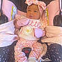 Azariah is registered to the contest to win money with this photo: baby, infant, car_seat, pink, mittens, headband, floral_pattern, clothing, cute, child, seatbelt, sitting, young, adorable, portrait, small, indoors, fabric, person, newborn