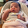 Azariah is registered to the contest to win money with this photo: baby, infant, blanket, pink, clothing, face, expression, curious, indoor, person, newborn, seat, cushion, soft, child, portrait, skin, hand, head, cozy