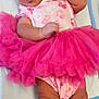 baby, newborn, yawning, pink_tutu, headband, barbie, hospital_blanket, baby_clothing, infant, cute, socks, lying_down, wrinkles, small_hands, baby_shoes, sleepy, portrait, indoors, child, adorable