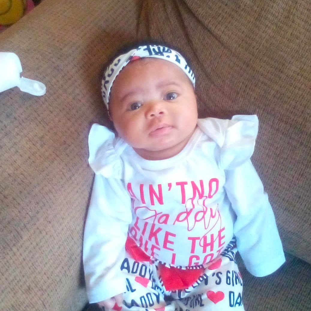 Inayah Starks joined the competition — help win amazing prizes! architecture, baby, building, clothing, couch, cushion, face, furniture, hat, head, homedecor, indoors, livingroom, newborn, pants, person, photography, portrait, sitting, t_shirt