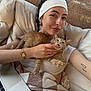 blanket, bracelet, brick_wall, casual, cat, couch, cozy, cute, finger, headband, home, indoor, kitten, laptop, pet, portrait, relaxing, smile, tattoo, woman