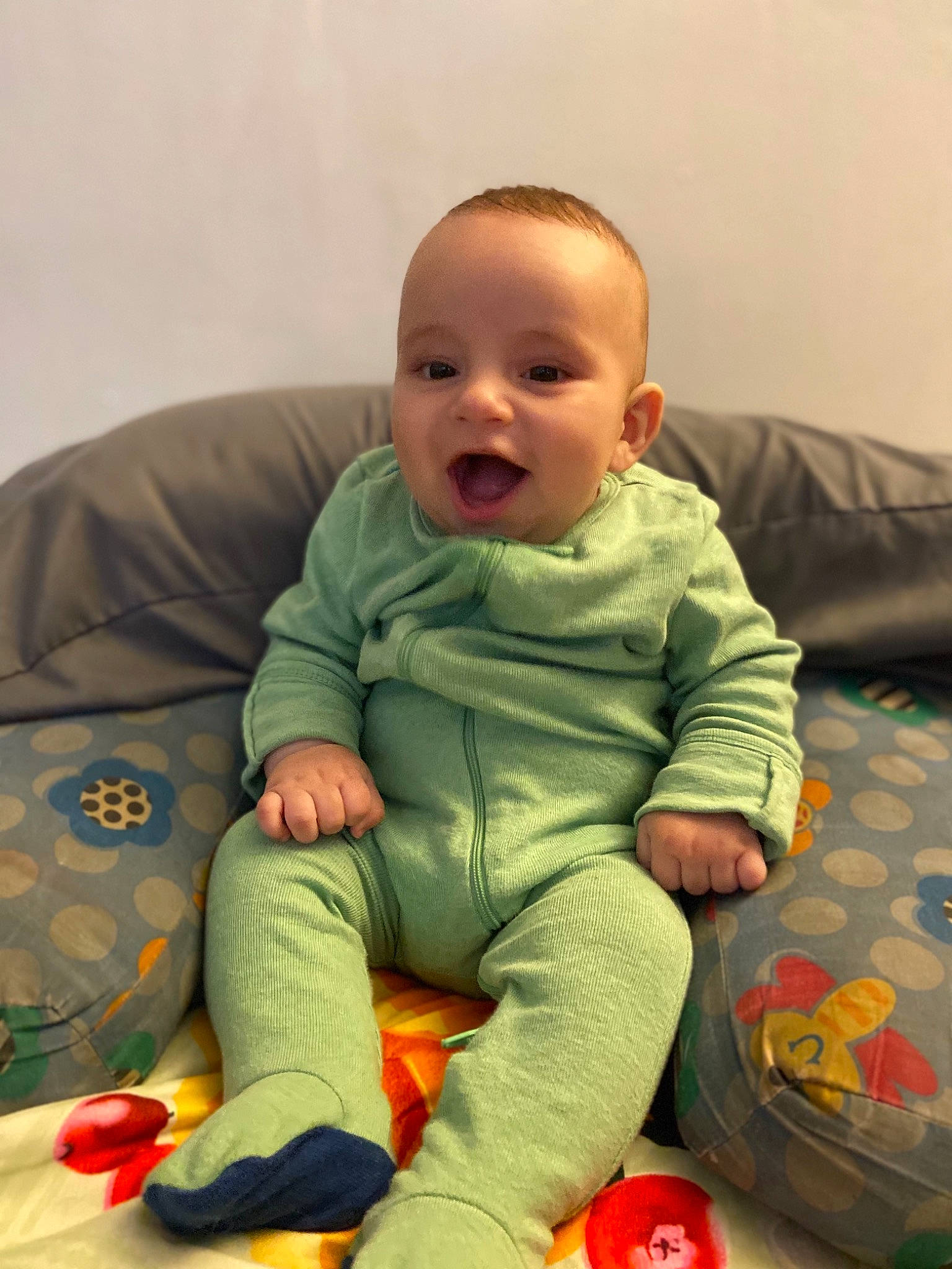 Wyatt is registered to the contest to win money with this photo: baby, baby_toddler_clothing, cheek, child, comfort, couch, face, finger, flooring, fun, head, mouth, nose, people, person, skin, sleeve, smile, sock, standing