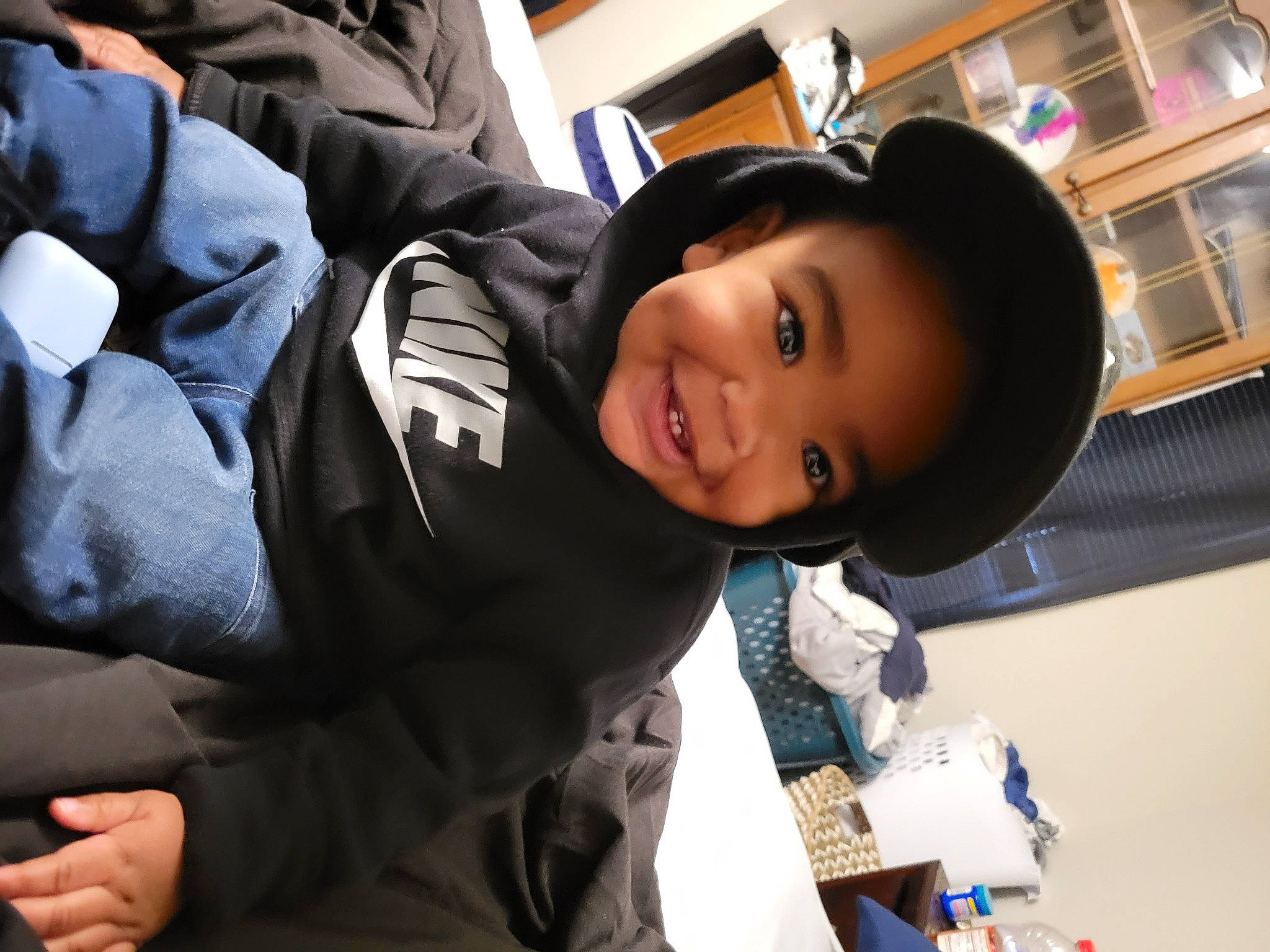 Armani is registered to the contest to win money with this photo: black_hair, child, comfort, fun, happy, joy, leisure, luxury_vehicle, person, room, sitting, smile, street_fashion, travel