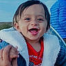 adult_hand, american_flag, baby, blue_jacket, child, clothing, coat, cute, face, hand, happy, jacket, outdoor, person, portrait, red_shirt, sky, smiling, toddler, warm