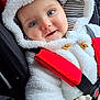 baby, child, infant, face, smile, hood, jacket, car_seat, seatbelt, toy, giraffe, striped, clothing, red, white, cute, blue_eyes, closeup, happy, portrait