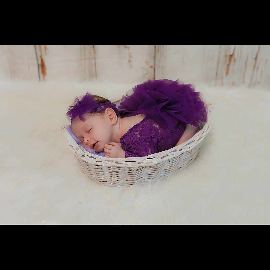 Bea joined the competition — help win amazing prizes! baby, cozy, cute, decor, fluffy_rug, headband, indoor, infant, lace, newborn, peaceful, portrait, purple_outfit, resting, sleeping, soft_texture, tulle, white, wicker_basket, wooden_background