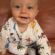 Kayron participe au concours pour gagner de l'argent avec cette photo : baby, child, infant, smile, blue_eyes, onesie, couch, sofa, hands, sock, portrait, indoor, cute, sitting, face, happy, hair, skin, closeup, clothing