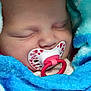 baby, sleeping, pacifier, blue_blanket, closeup, infant, cute, face, newborn, soft_texture, cozy, wrapped, child, peaceful, mouth, pink, red_hearts, adorable, resting, portrait