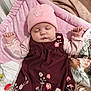 Célia participe au concours pour gagner de l'argent avec cette photo : baby, sleeping, pink_hat, maroon_dress, floral_embroidery, blanket, baby_rattle, soft_texture, indoors, infant, peaceful, cute, child, resting, pink, clothing, hand, face, headwear, cozy