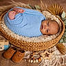 baby, newborn, basket, blue_blanket, wooden_toy, baby_shoes, wooden_beads, autumn_decor, dried_leaves, cozy, portrait, infant, wrapped, soft_texture, floor, cute, peaceful, indoor, head, face