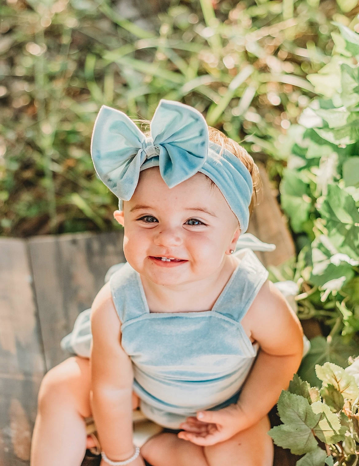 Kenadeigh is registered to the contest to win money with this photo: azure, baby, baby_toddler_clothing, cap, costume_hat, electric_blue, face, fun, grass, happy, headband, headgear, headpiece, headwear, insect, joy, leisure, people_in_nature, person, plant