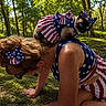 animal, bow, cat, costume, dress, forest, glasses, grass, nature, outdoor, patriotic, pet, red_white_blue, siamese_cat, stars_and_stripes, summer, sunlight, tattoo, trees, woman