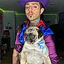 Gojo joined the competition — help win amazing prizes! person, pug, dog, purple_hat, tattoos, indoor, led_lights, blue_bow, purple_shirt, red_ribbons, pet, animal, portrait, costume, facial_hair, makeup, living_room, furniture, cute, holding