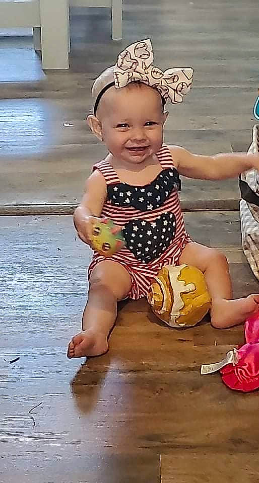 Anastasia is registered to the contest to win money with this photo: baby, baby_toddler_clothing, barefoot, flooring, foot, fun, happy, hat, headgear, human_leg, joy, leisure, pattern, person, pink, shorts, sitting, skin, smile, snapshot