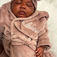 Cyanii joined the competition — help win amazing prizes! baby, sleeping, plush_robe, pink, bow, face, hand, cozy, soft_texture, newborn, infant, cute, peaceful, portrait, child, wrapped, love, clothing, indoors, resting