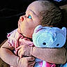 Amara is registered to the contest to win money with this photo: baby, infant, plush_toy, stuffed_animal, owl, pink_clothing, cute, child, portrait, soft_toy, hand, arm, closeup, curious, looking_away, indoor, newborn, holding, cozy, warm_lighting