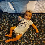 Christopher joined the competition — help win amazing prizes! baby, infant, onesie, playpen, mattress, floral_pattern, cartoon_dog, child, lying_down, indoor, person, cute, face, foot, hand, head, sleepwear, textile, pattern, soft_furnishing