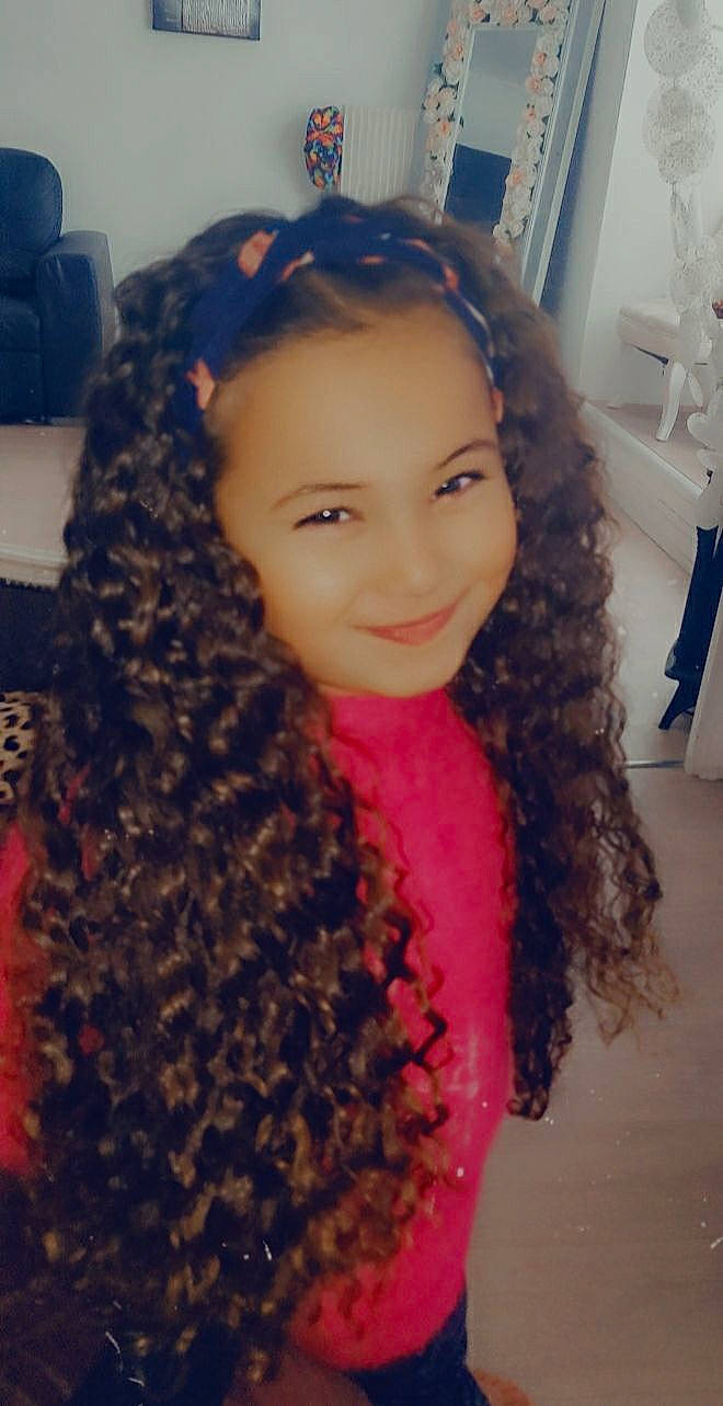 Alia participe au concours pour gagner de l'argent avec cette photo : black_hair, blue, chair, chin, electric_blue, eyebrow, eyelash, forehead, hair, happy, head, iris, jheri_curl, joy, lip, long_hair, makeover, neck, nose, person