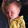 baby, sleeping, infant, yellow_clothing, striped, hair, spiky_hair, face, closed_eyes, peaceful, cozy, cute, child, portrait, soft_lighting, newborn, relaxing, rest, person, indoors