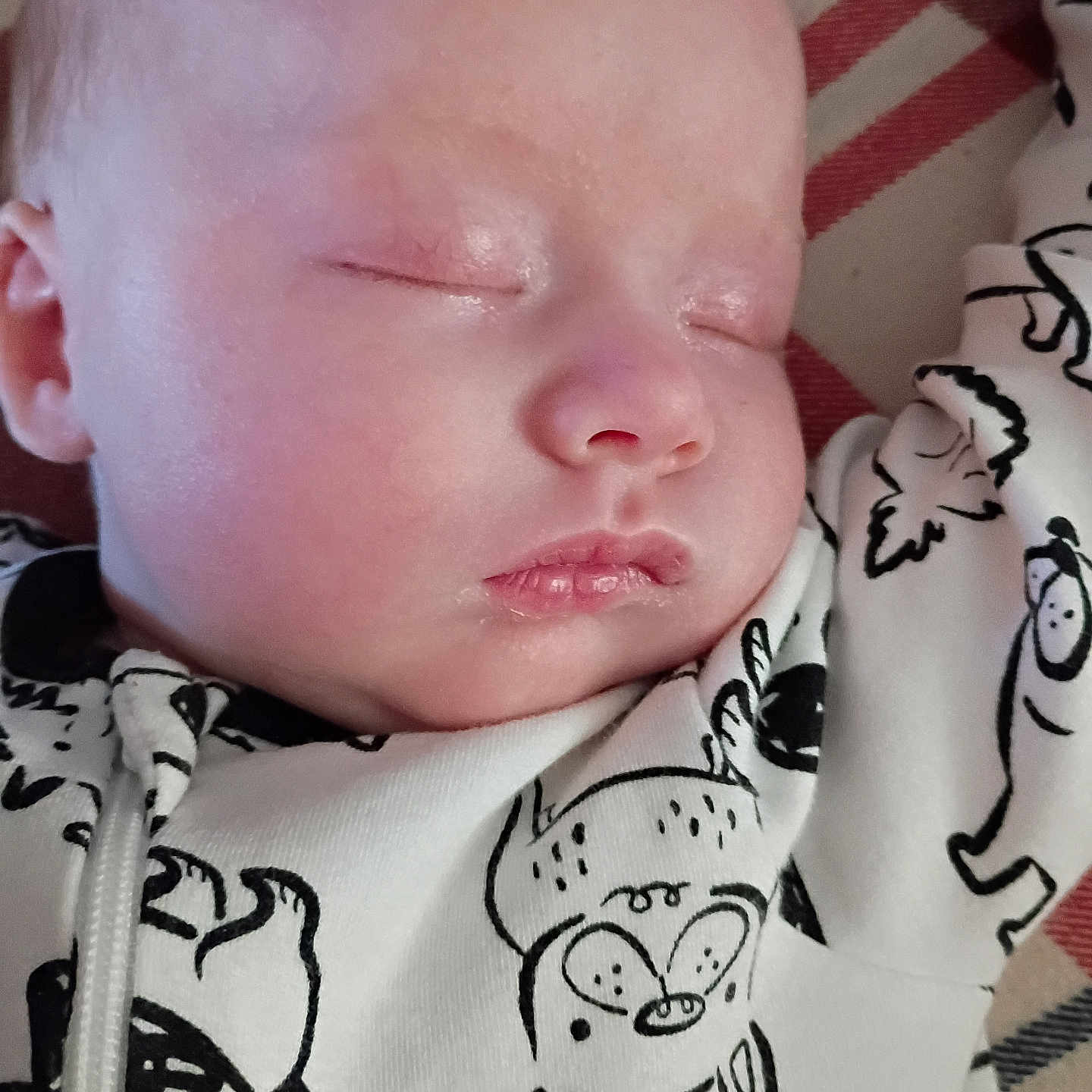 Brieahlana is registered to the contest to win money with this photo: adorable, baby, blanket, cartoon_print, child, closeup, clothing, comfort, cute, face, indoors, infant, onesie, peaceful, portrait, relaxation, resting, sleeping, soft_skin, young