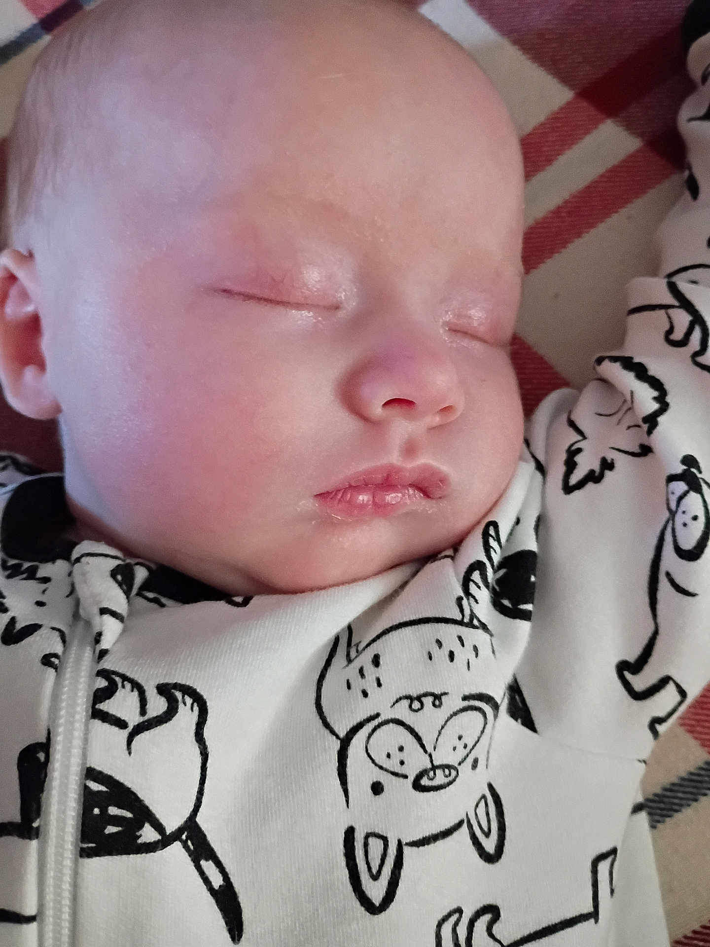 Brieahlana is registered to the contest to win money with this photo: adorable, baby, blanket, cartoon_print, child, closeup, clothing, comfort, cute, face, indoors, infant, onesie, peaceful, portrait, relaxation, resting, sleeping, soft_skin, young