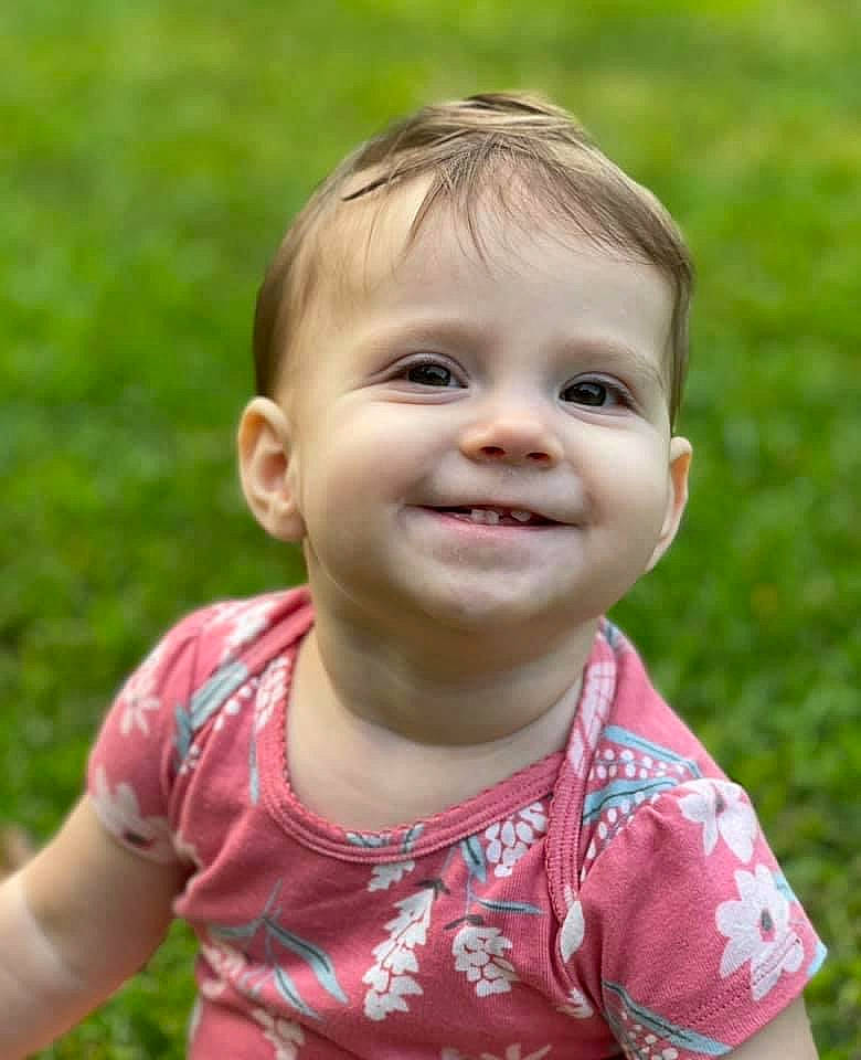 Ainsley is registered to the contest to win money with this photo: baby, baby_toddler_clothing, cheek, chin, dress, eye, eyelash, face, grass, hair, happy, iris, joy, lip, mouth, nose, people_in_nature, person, pink, plant