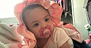 Kaileeanna joined the competition — help win amazing prizes! baby, pacifier, pink_bonnet, blanket, indoor, clothing, face, child, person, cute, infant, portrait, soft_lighting, bedroom, toddler, cozy, resting, apparel, headwear, laying_down