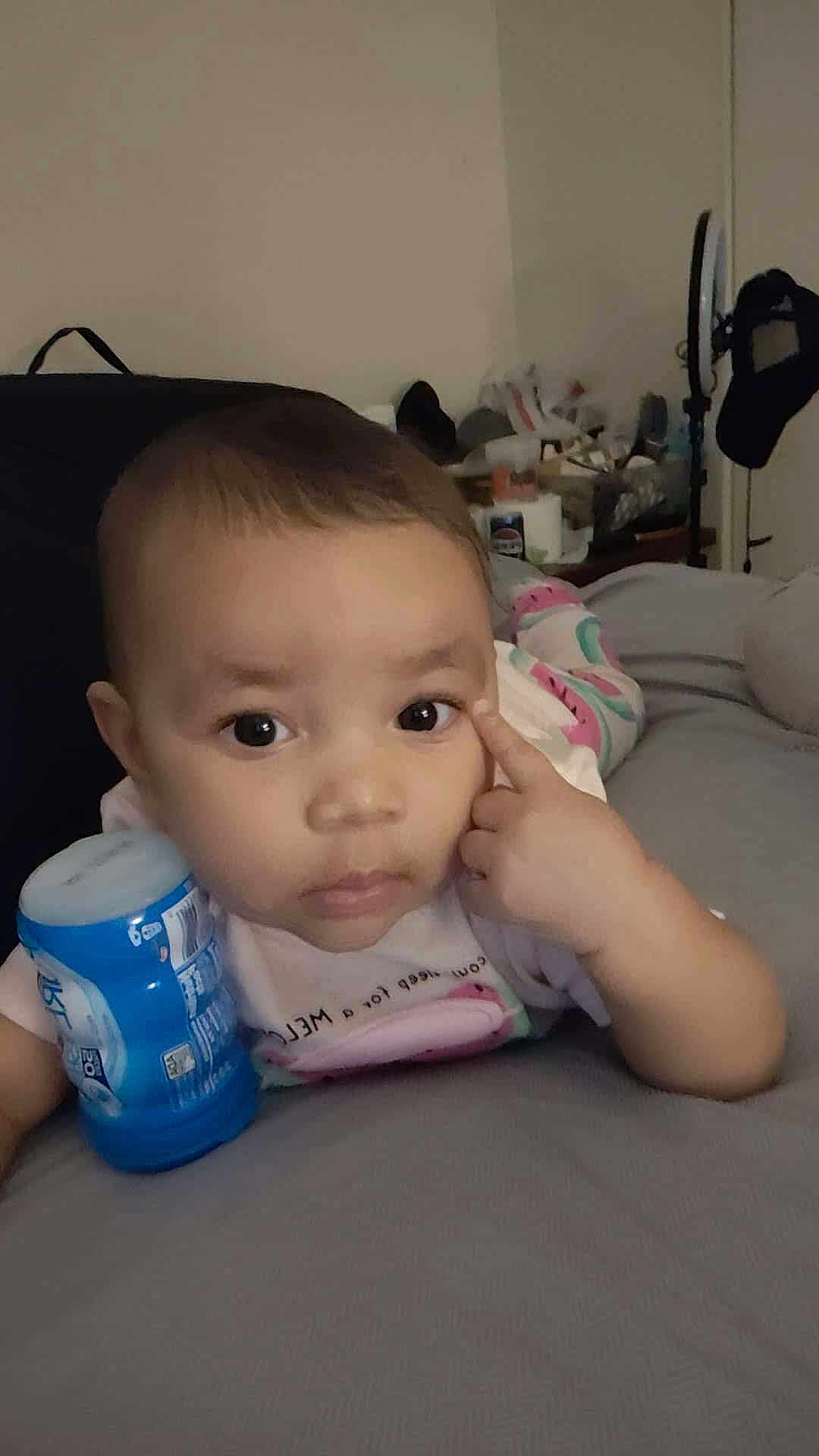 Aaliyah joined the competition — help win amazing prizes! baby, child, indoor, bed, blanket, clothing, container, curious, face, finger, furniture, holding, infant, person, portrait, sleepsuit, toddler, young_child, expression, lying_down