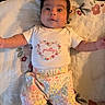 Victoria joined the competition — help win amazing prizes! baby, infant, child, cute, lying_down, floral_pattern, blanket, clothing, heart_shape, smiling, face, arms, cute_outfit, text_on_clothes, indoors, portrait, colorful, happy, soft_light, person