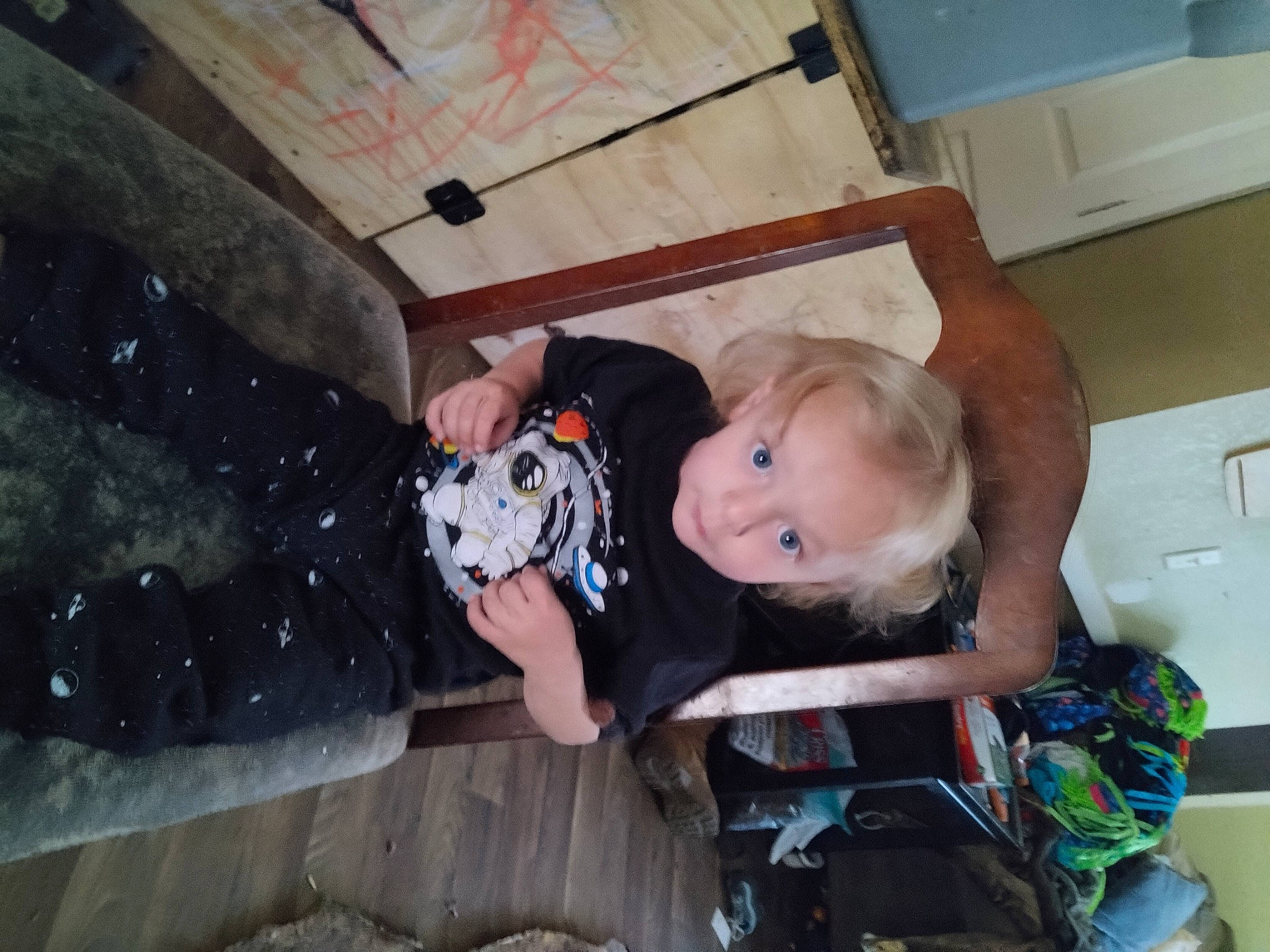 Kaleb is registered to the contest to win money with this photo: baby, baby_products, baby_toddler_clothing, bag, cabinetry, chair, child, fun, happy, kitchen_appliance, luggage_and_bags, person, room, sitting, toddler, tree, vacation, wood