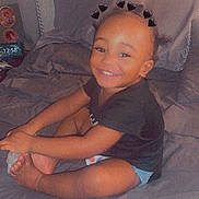 Carvin joined the competition — help win amazing prizes! toddler, child, smiling, bed, bedding, black_heart_filter, hands, feet, hair, indoor, happy, person, cute, clothing, shorts, shirt, pillow, room, portrait, sitting